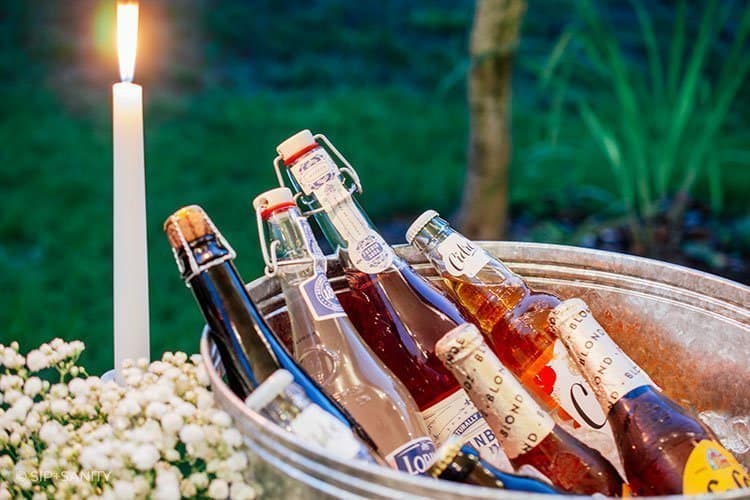 tub filled with bottles and a candle