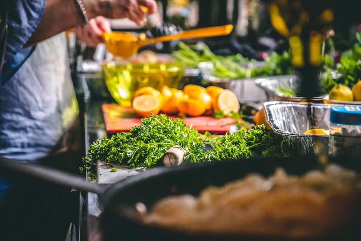 spread of food and a cook in the kitchen
