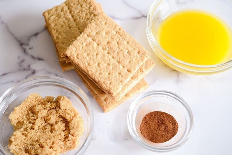 graham crackers, melted butter, brown sugar and spices on a counter