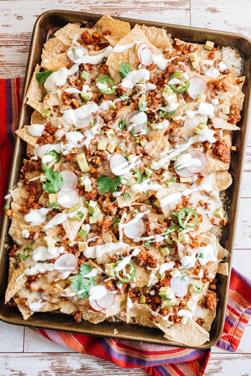 Overhead shot of a sheet pan filled with nachos.