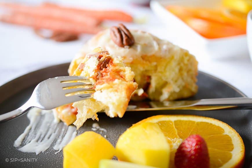 a forkful of orange carrot cinnamon roll