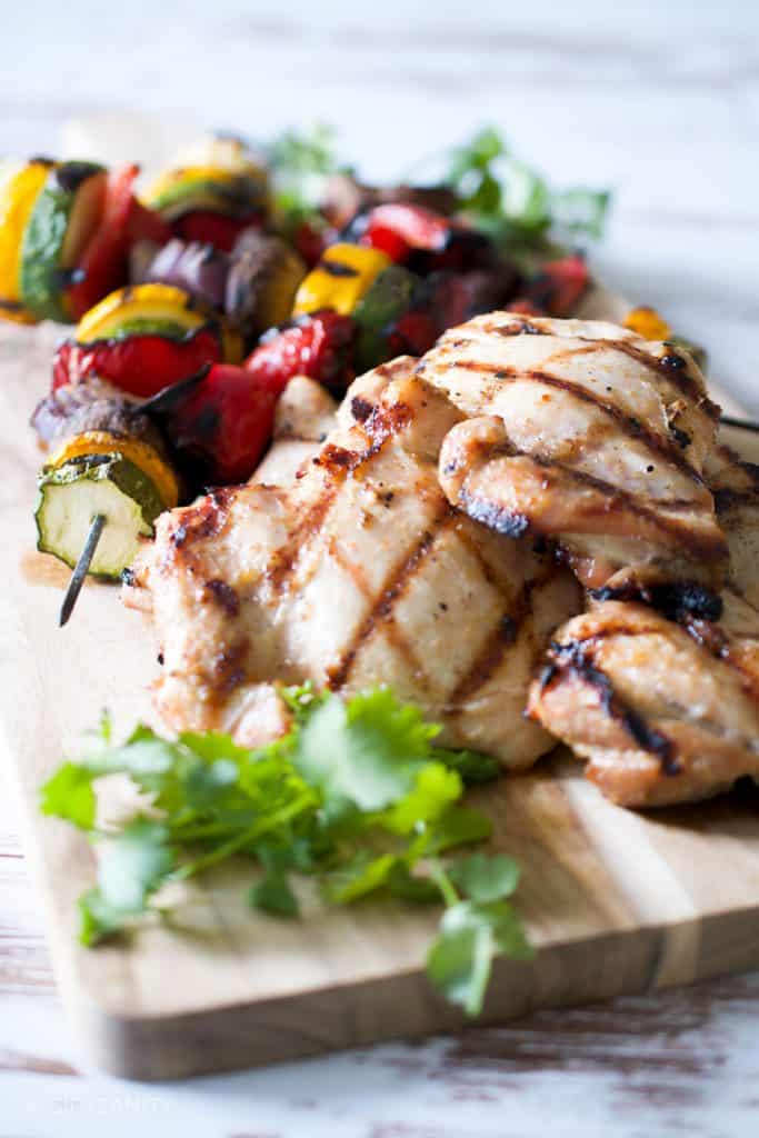 grilled vegetables and chicken on a cutting board