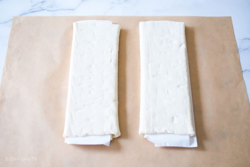 two sheets of folded puff pastry on parchment