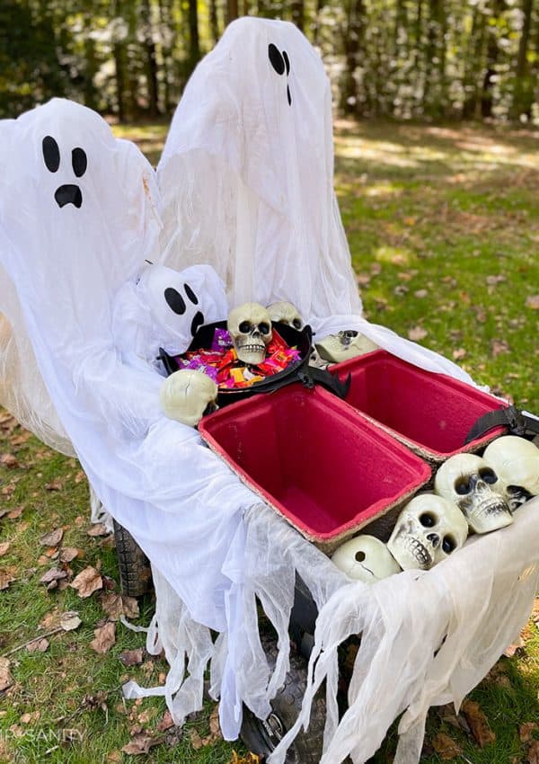 completed halloween party on wheels with ghosts, candy, coolers and plastic skulls