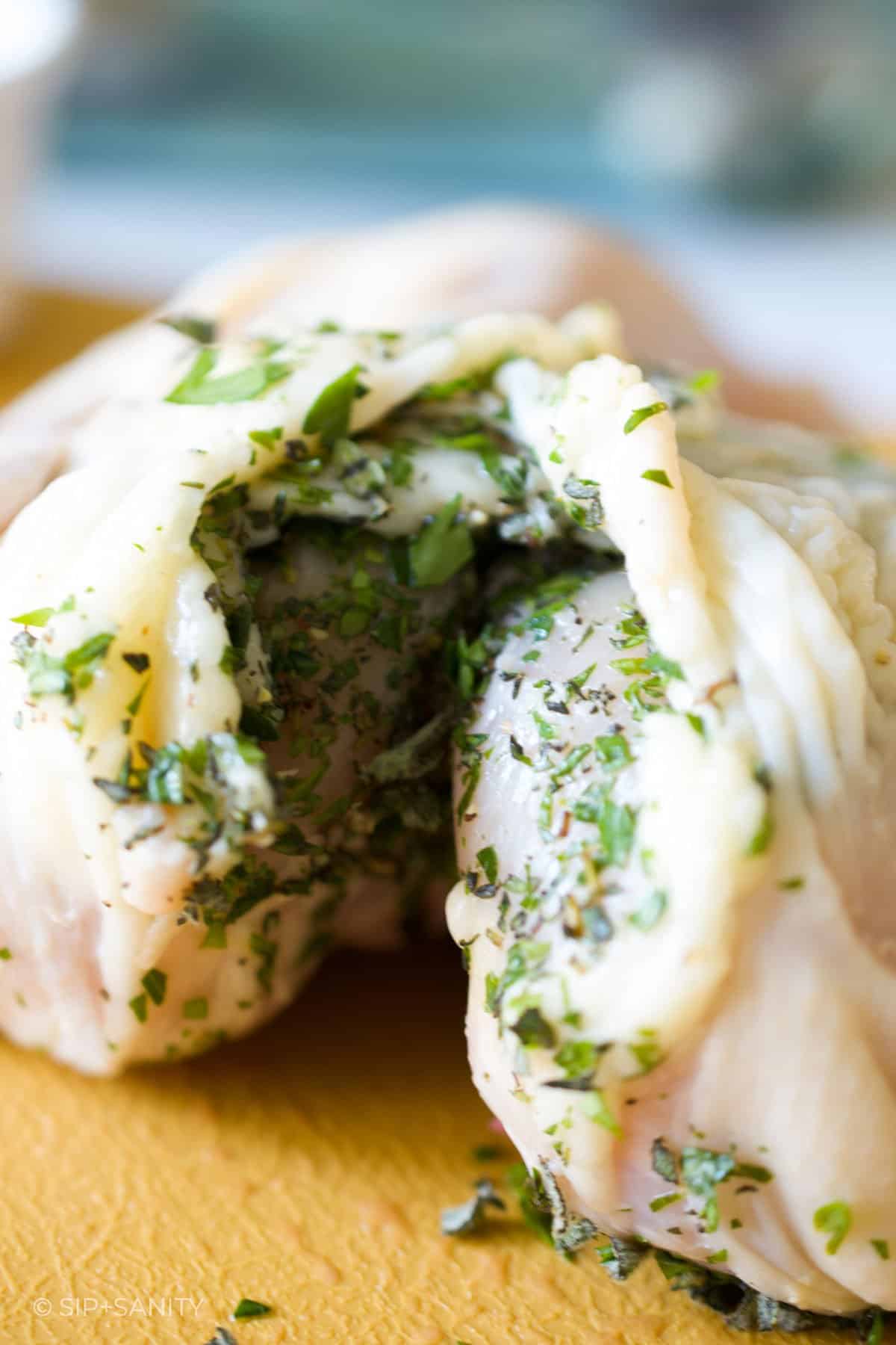 herbs stuffed between the skin and breast of a cornish hen