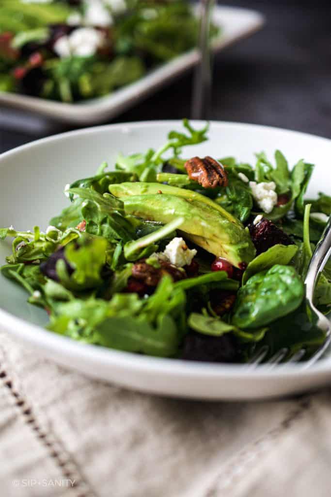 serving of beet and baby greens salad with maple mustard dressing