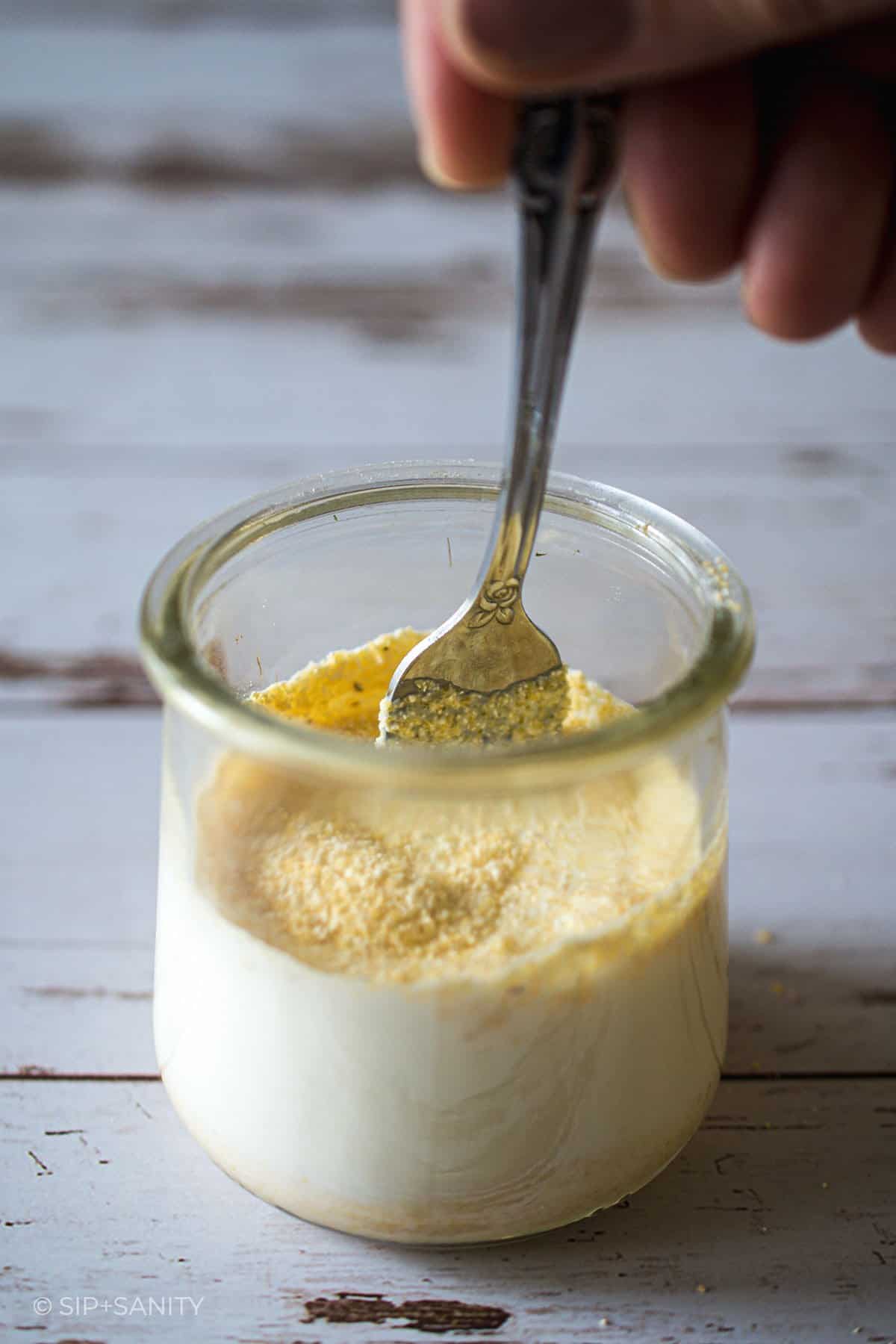 Stirring cornmeal into cream.