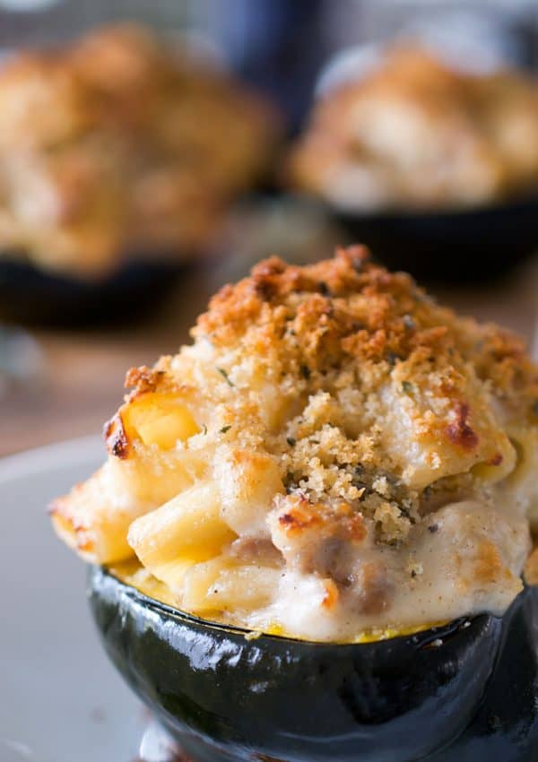 a halved acorn squash stuffed with mac and cheese