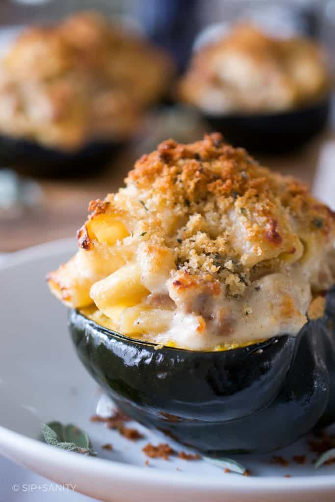a halved acorn squash stuffed with mac and cheese