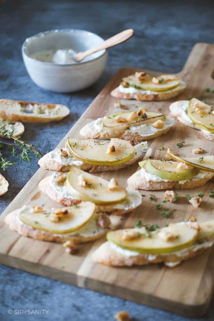 bruleed pear and feta crostini on a board