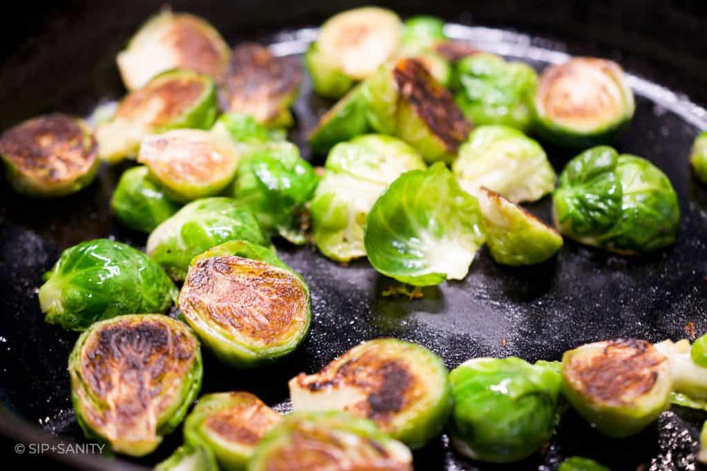 brussels sprouts caramelizing in a skillet