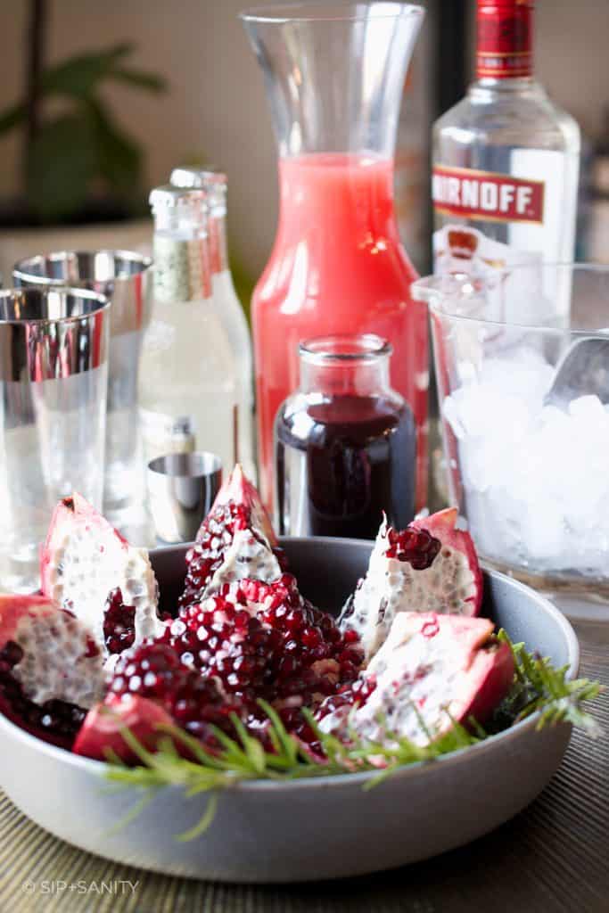 cocktail ingredients and a cut pomegranate
