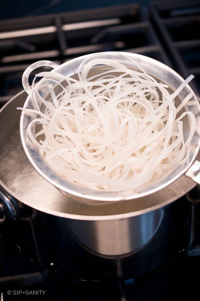 softening rice noodles in simmering water