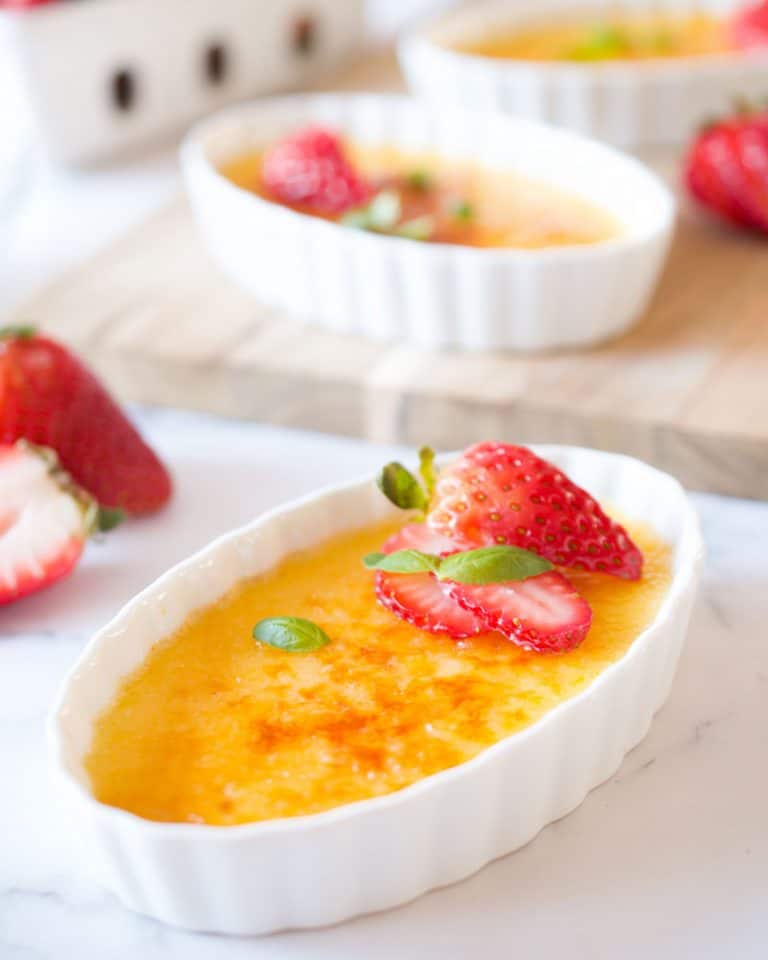 Basil creme brûlée with strawberries.