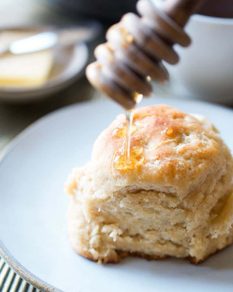 Drizzling honey over a honey wheat angel biscuit.