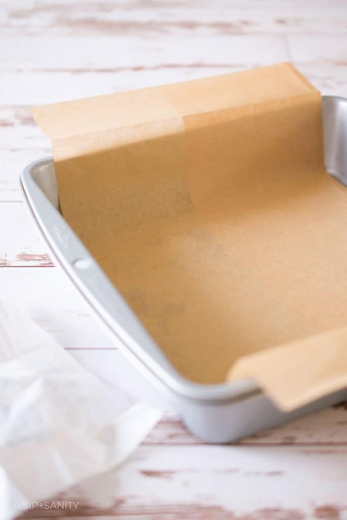 A baking pan lined with a sheet of parchment paper.