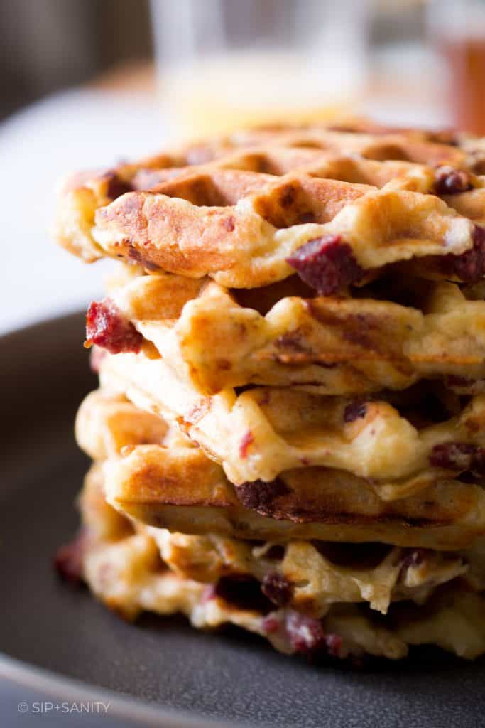 A stack of corned beef hash waffles on a plate.