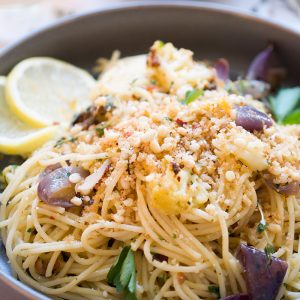 A bowl of spaghettini with roasted cauliflower topped with breadcrumbs.