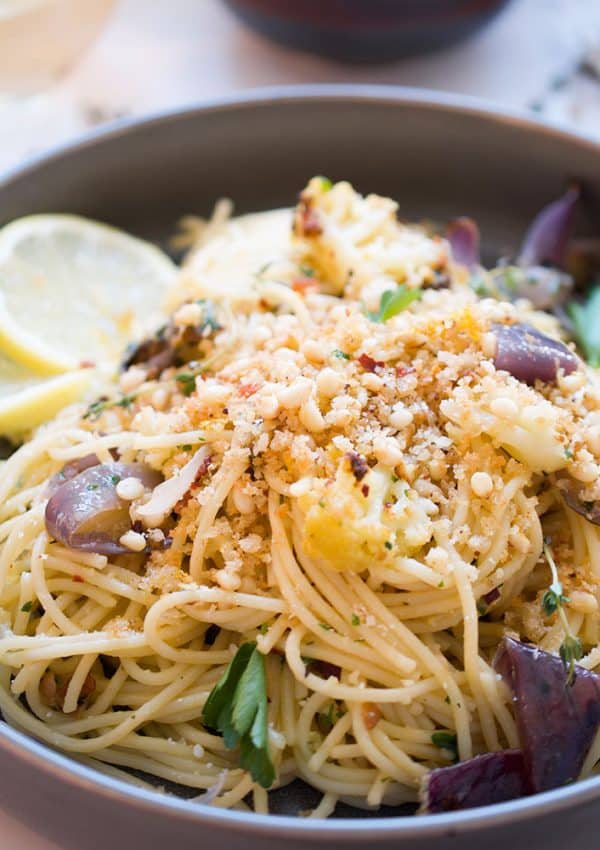 A bowl of spaghettini with roasted cauliflower topped with breadcrumbs.