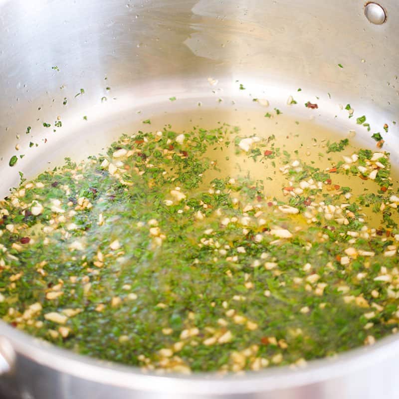 Parsley, garlic, red pepper flakes and olive oil in a pot.