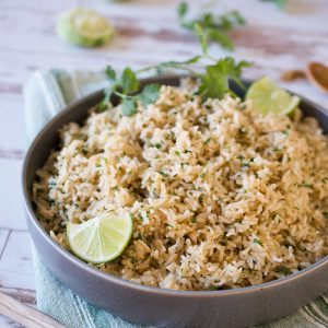 A bowl of instant pot cilantro lime brown rice on a wooden table.