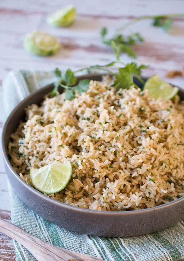 A bowl of instant pot cilantro lime brown rice on a wooden table.