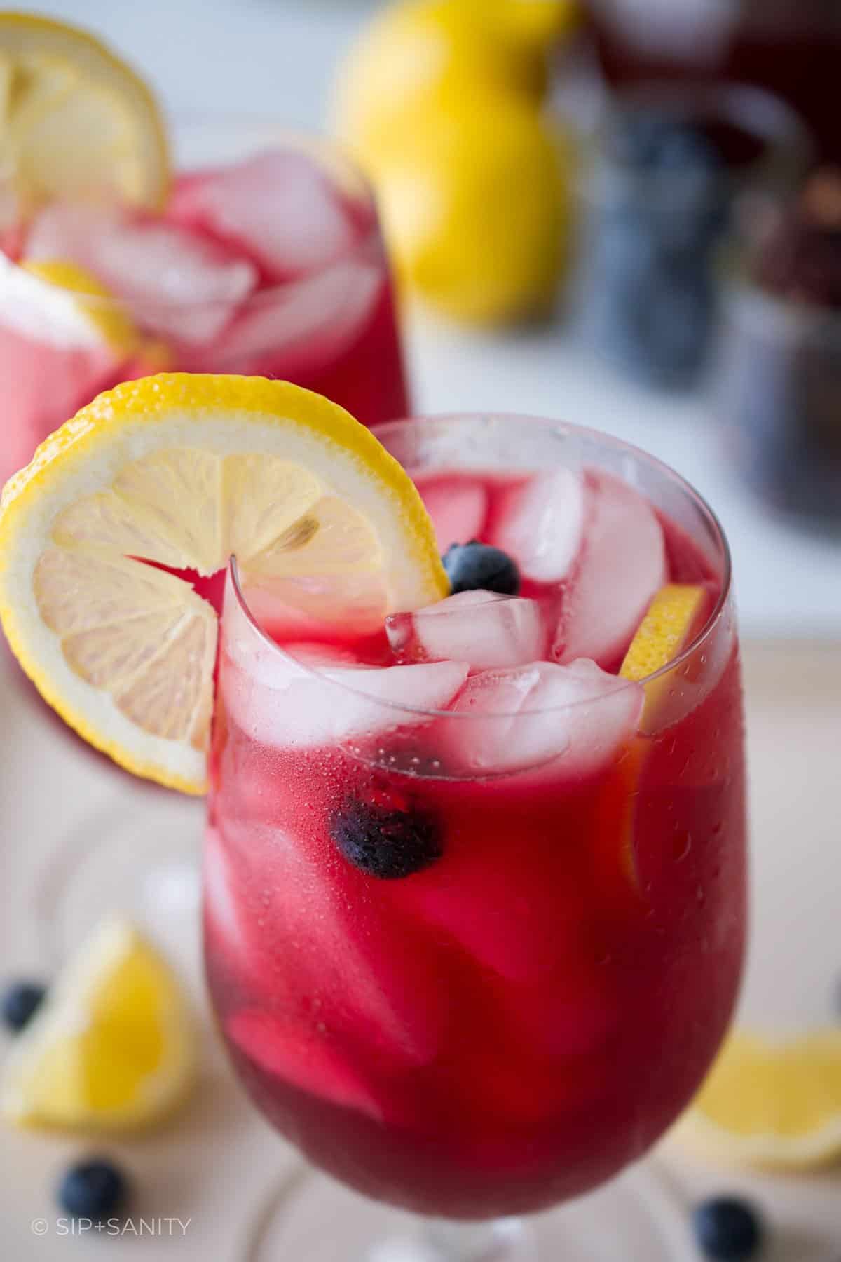 Two glasses of blueberry hibiscus lemonade.