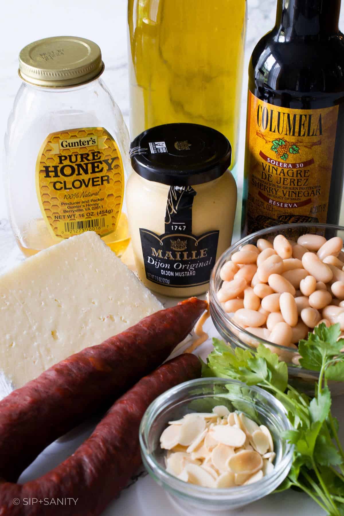 Raw ingredients for easy tapas white beans salad with chorizo and manchego.
