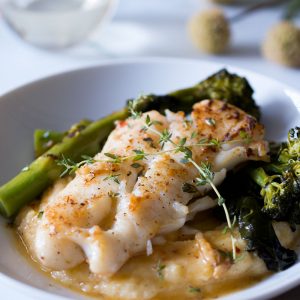 Sautéed white fish fillet on a bed of creamy polenta and broccolini.