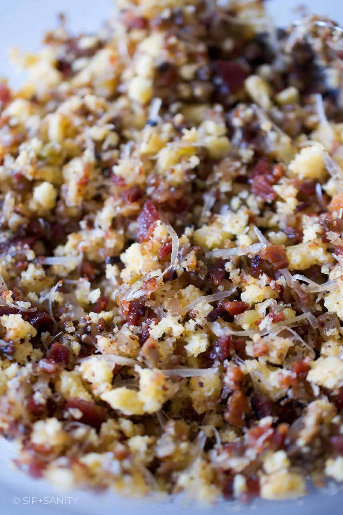 A bowl of cornbread and bacon stuffing.