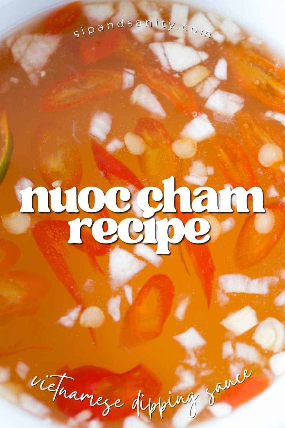 Close-up of Nước chắm sauce with chili, garlic, onion in orange liquid. Text: nuoc cham recipe and vietnamese dipping sauce.