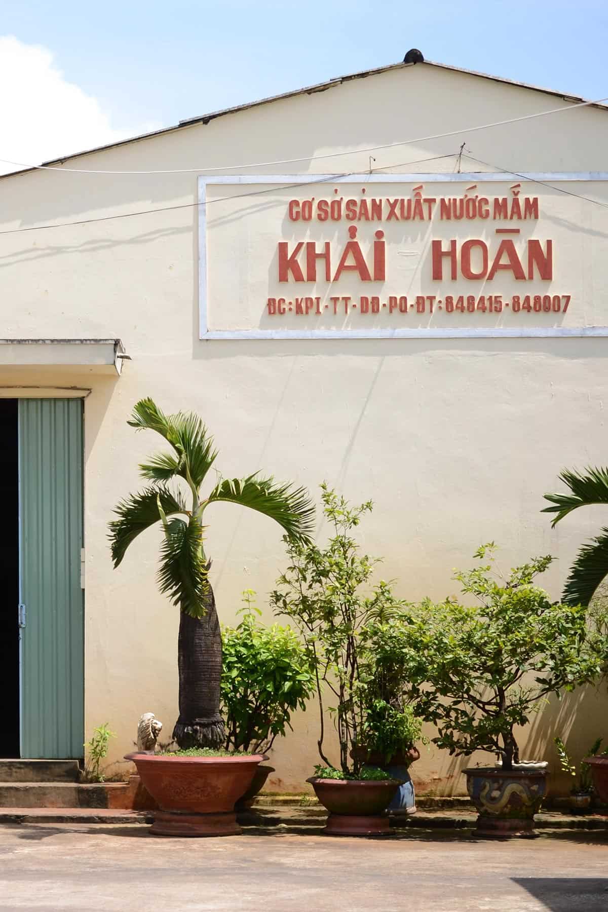 Large wooden vats inside a fish sauce factory.