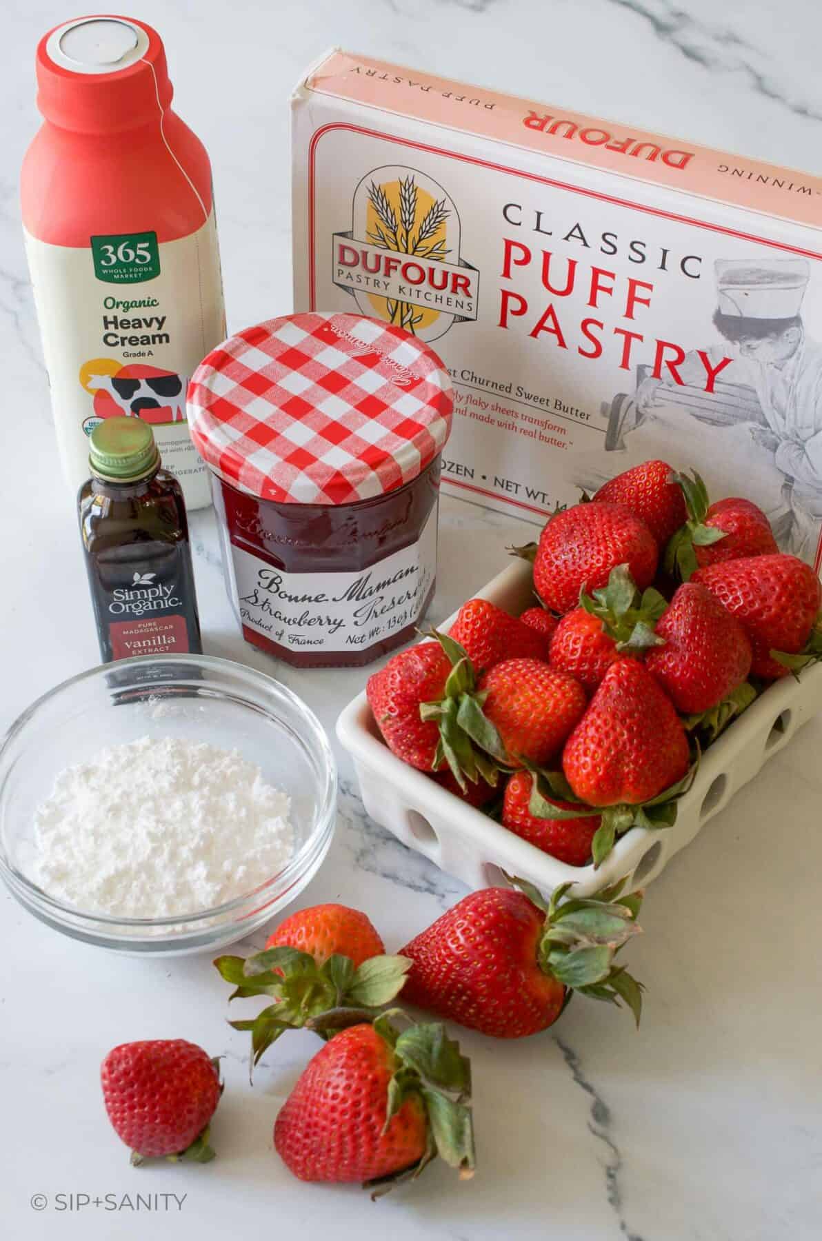 Raw ingredients for giant strawberry shortcake dessert with puff pastry.