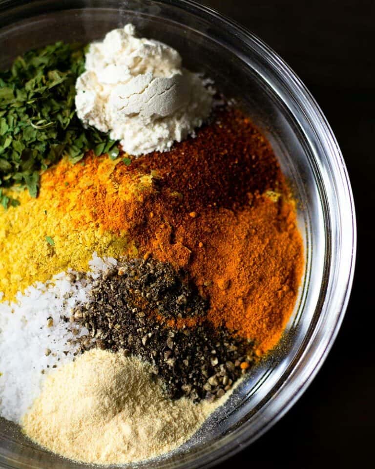 A glass bowl filled with piles of spices, Photo by Christina Rumpf on Unsplash.