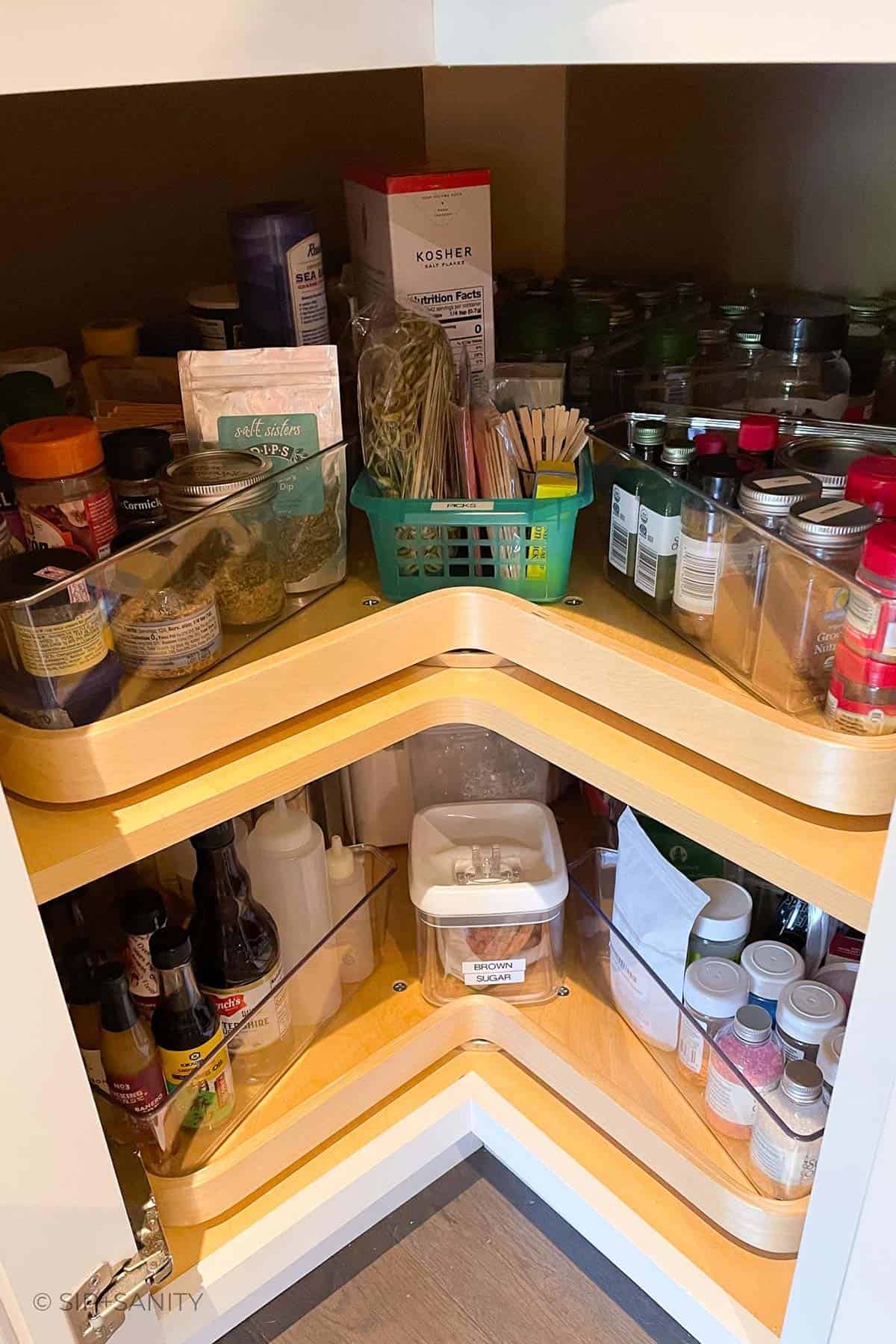 A lazy susan spice cabinet after being reorganized.