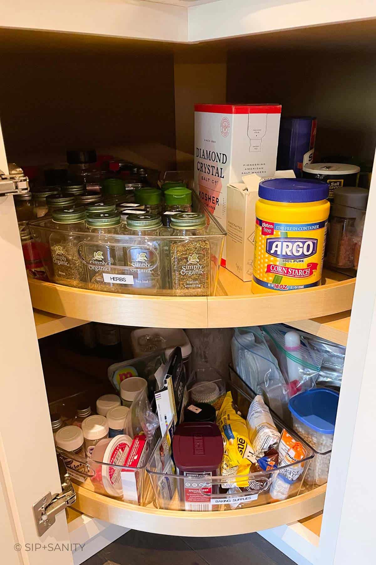 A lazy susan spice cabinet after being neatly reorganized.