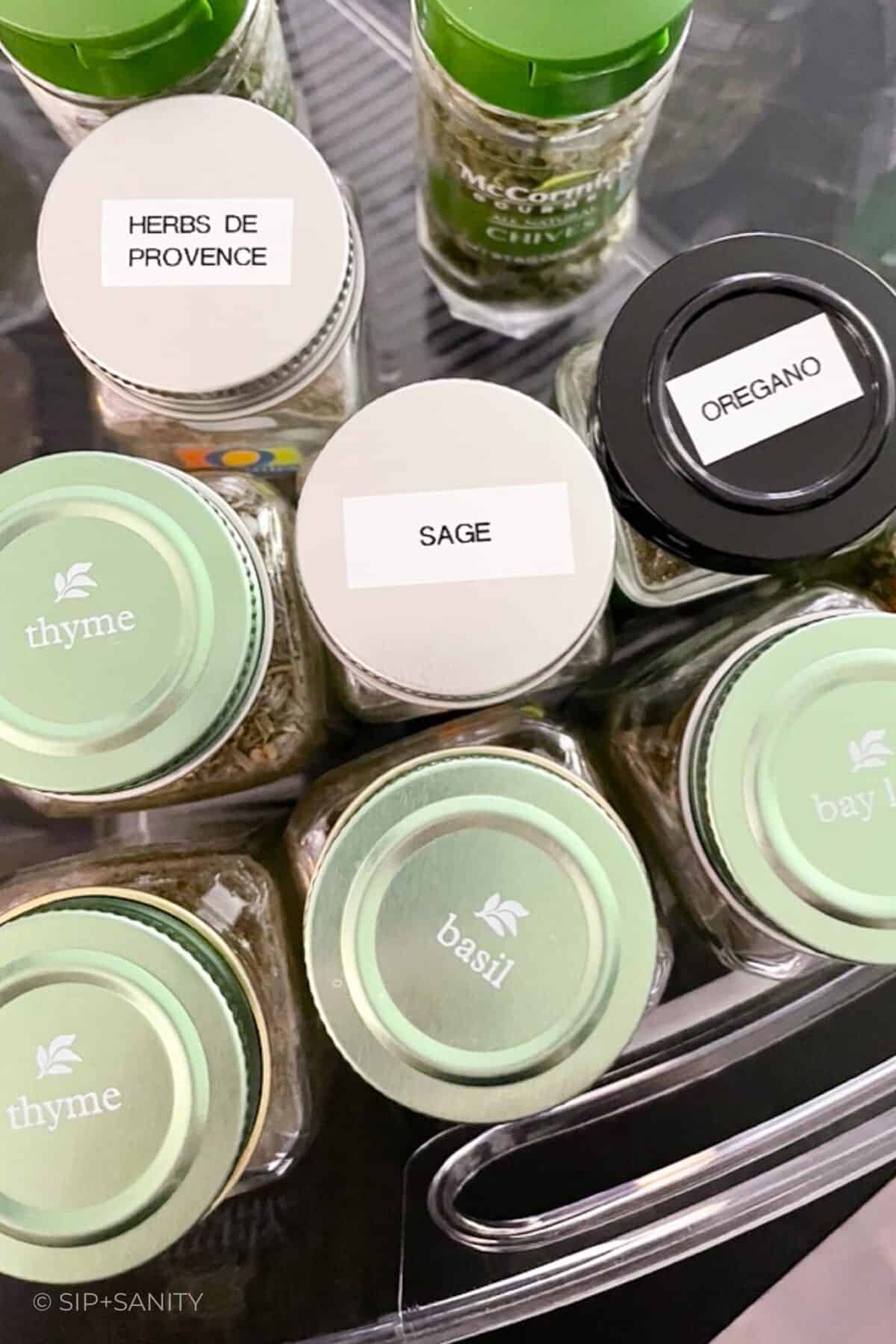 The tops of spice bottles labeled with their contents.