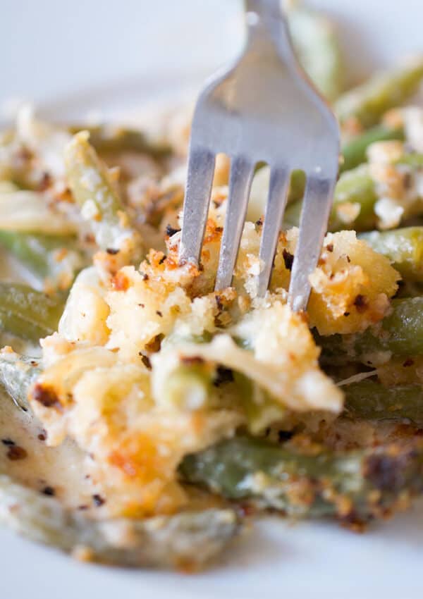 A forkful of creamy french onion green bean casserole.