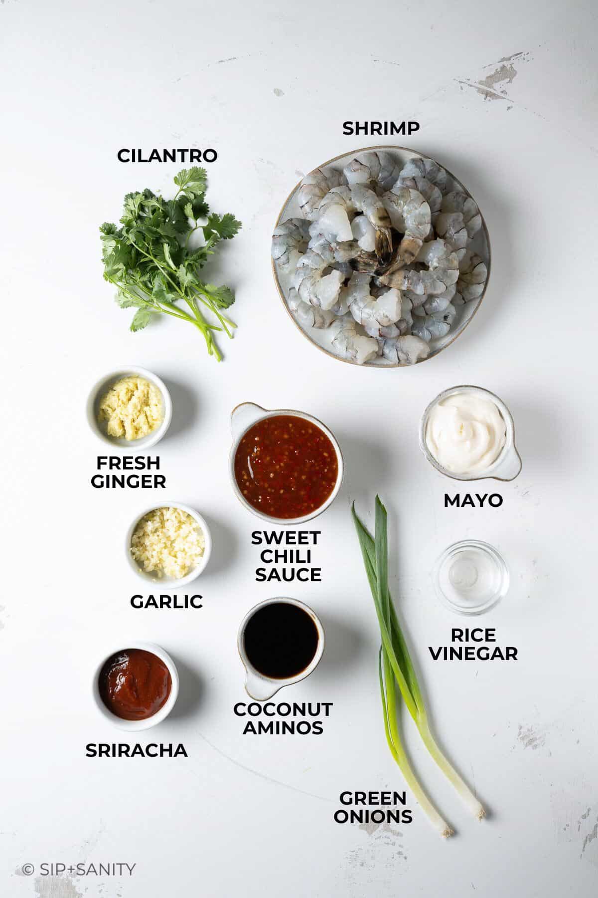 Raw ingredients for firecracker shrimp arranged on a table.