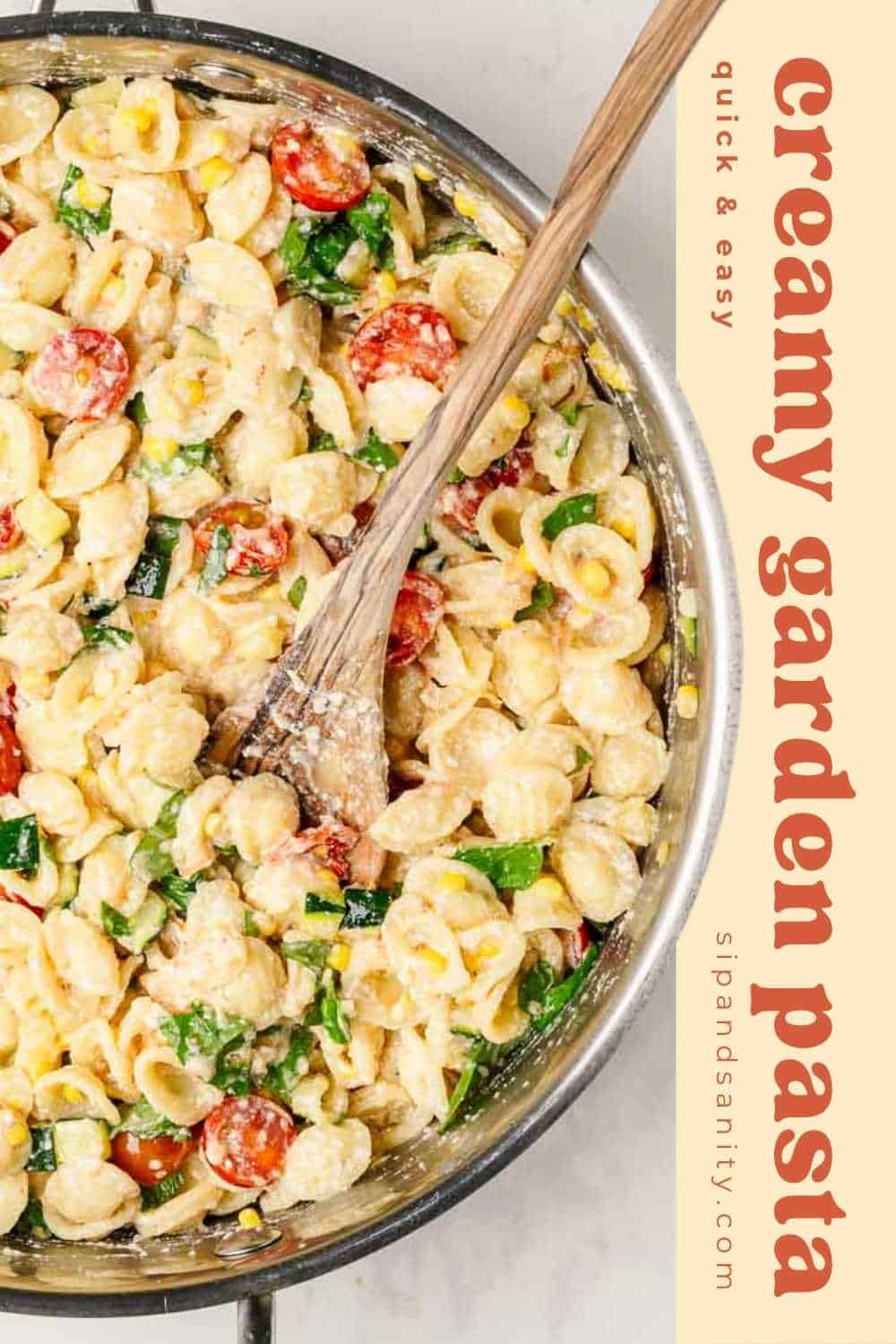 A skillet filled with creamy pasta shells mixed with cherry tomatoes, spinach, zucchini, and herbs, stirred with a wooden spoon; text beside reads, “creamy garden pasta, quick & easy".