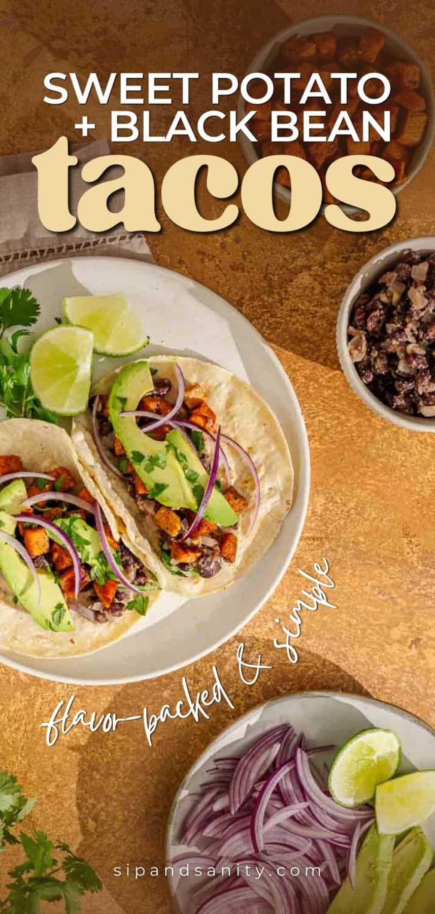 Overhead of sweet potato and black bean tacos with avocado, onion, cilantro, limes. Text: “Sweet Potato + Black Bean Tacos.”.