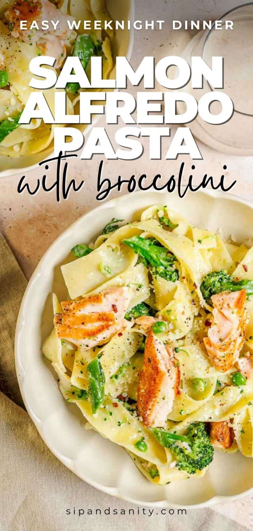Bowl of wide pasta noodles, broccolini, peas, and salmon in creamy Alfredo sauce. Text: Salmon Alfredo Pasta with broccolini.