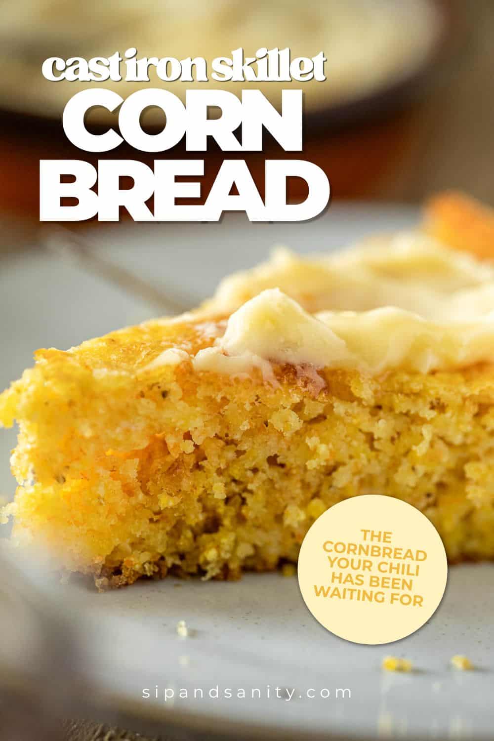 Slice of skillet cornbread with butter on a plate. Text: Cast Iron Skillet Corn Bread. sipandsanity.com.
