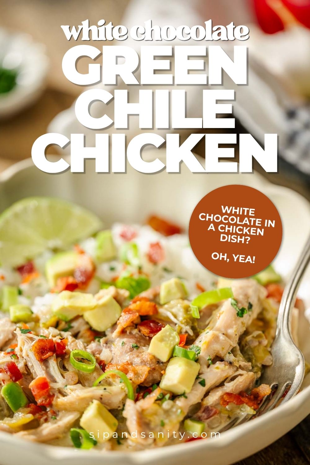 Green chile chicken in a bowl with avocado, red peppers, herbs, lime wedge. Text: White Chocolate Green Chile Chicken.