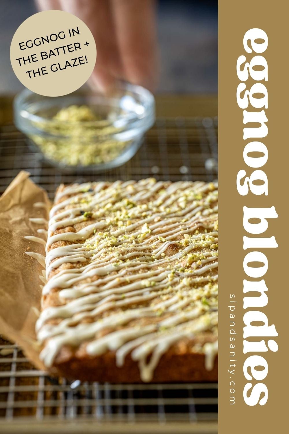 Eggnog blondies with icing and crushed pistachios on a wire rack, with text overlay.
